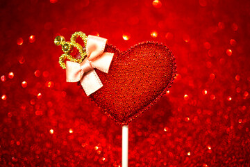 Valentines day background, red heart on red shiny glitter background. Copy space photo
