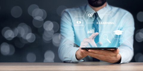 Businessman holding tablet with e-learning