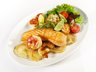 Low Carb Pan Fried Fish Fillet on grilled Vegetables - Roasted Salmon and Prawns on a Plate isolated on white Background