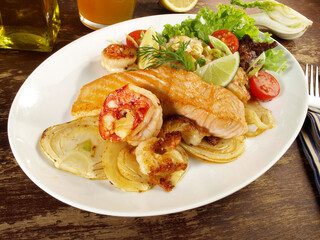 Low Carb Pan Fried Fish Fillet Mix on grilled Vegetables - Roasted Salmon and Prawns on a Plate on...