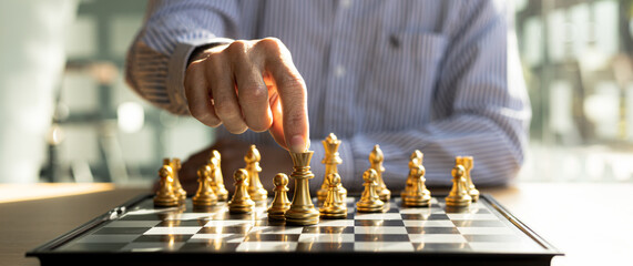 Person playing chess board game, business man concept image holding chess pieces like business...