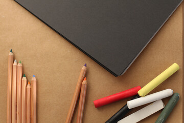 Empty copy space paper canvas and color pencils, pastel chalk. Flat lay, top view.