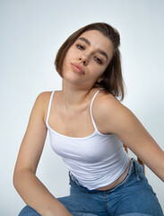 White european woman with bob cut on white in a top and blue jeans