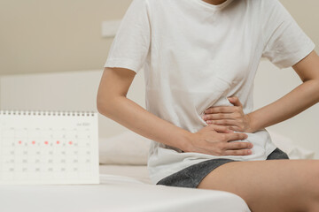 Menstruation, period cycle day of monthly, hurt asian young woman, female hand in stomachache,...