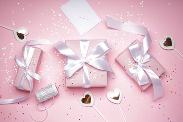 Gift boxes for Valentine's Day on a pink background, flat lay.