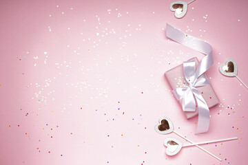 Gift box for Valentine's Day on pink background, space for tex, top view.