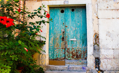 Fototapeta na wymiar Obidos, Portugal, old house with colorful wooden door, in the municipality of Santa Maria, São Pedro e Sobral da Lagoa, Eastern Region