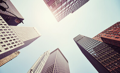 Manhattan skyscrapers against the sun, color toned picture, New York City, USA.