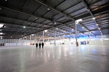 Exhibition hall of Kiev Expo center, blurred stands and people walking on a background. Kiev,...