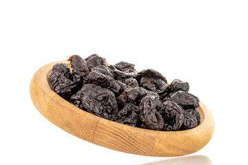 Several organic sweet prunes on a wooden tray, close-up, isolated on white.