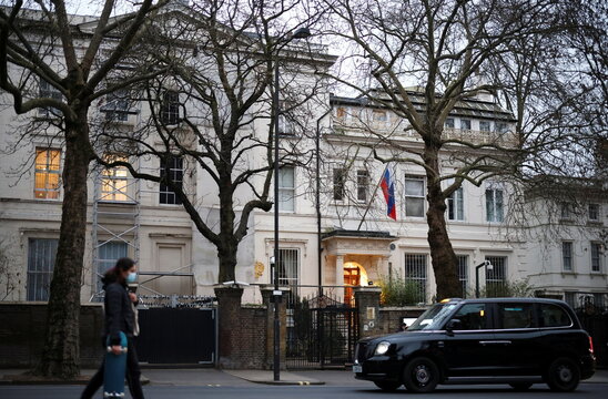 A person walks in front of the Russian embassy in London