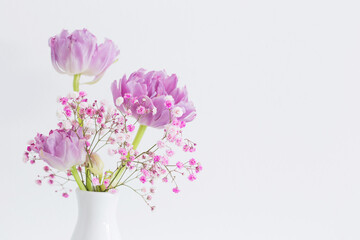 Naklejka na ściany i meble pink tulips and gypsophila on white background