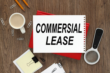 Commercial Lease. text written on a notebook with pencils