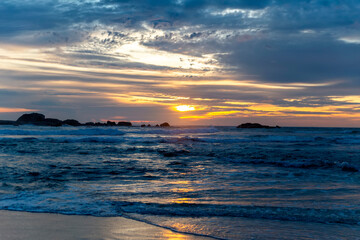 Fototapeta na wymiar Sunset on the beach by the ocean