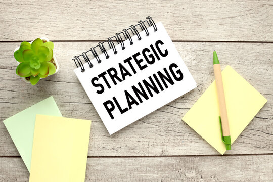 Strategic Planning Open Notepad With Text On Rustic Background And Yellow Sticky Notes