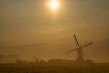 Fototapeta na wymiar Windmill the Wingerdse Molen on a misty morning