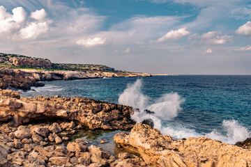 Rocky coast and water splashing wave near Cape Greco in Ayia Napa, Cyprus. National Forest park.