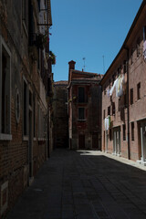 Fototapeta na wymiar View of a secluded little street in Venice in summer