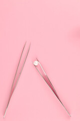 Equipment for eyelash extensions on pink background 