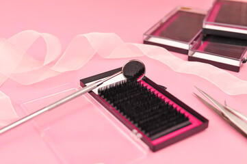 Equipment for eyelash extensions on pink background 