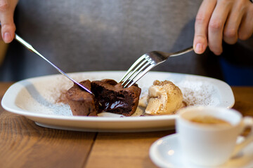 Chocolate background spreads. Chocolate dessert. Chocolate dessert. Hot cupcake with filling. Dessert is hot. Hot chocolate fondant in a restaurant. Brown cupcake. Junk food with sugar. Dessert with 