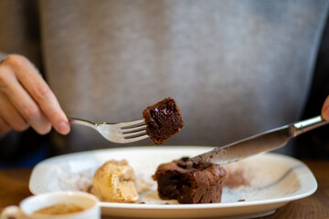 Chocolate background spreads. Chocolate dessert. Chocolate dessert. Hot cupcake with filling. Dessert is hot. Hot chocolate fondant in a restaurant. Brown cupcake. Junk food with sugar. Dessert with 