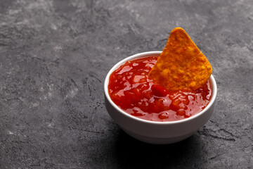 Sweet and sour red sauce with corn chips