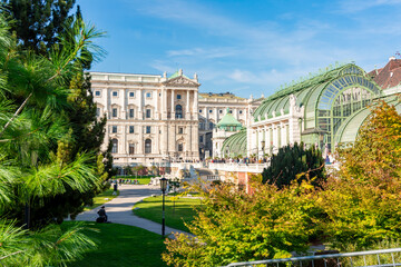 Fototapeta na wymiar Burggarten park with Butterfly house and Hofburg palace, Vienna, Austria