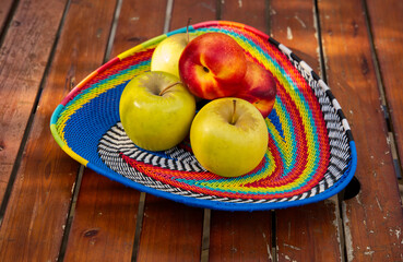 Beautiful colourful fruit basket on a wooden table. 