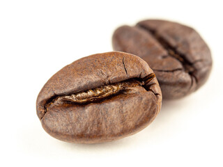 Coffee beans are Robusta. On a white background. Robusta is praised for its high caffeine content, low sugar content and low acidity. Selective focus.