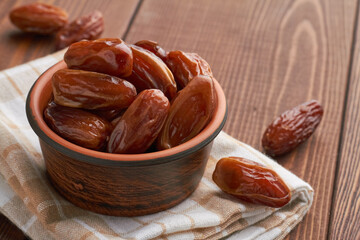 dates food in a bowl on brown background