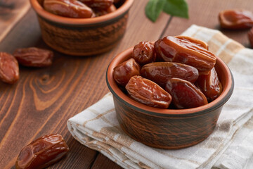 dates food in a bowl on brown background