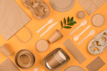 Eco-friendly tableware - kraft paper food packaging on yellow or orange background. Street food...