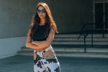 Naklejka premium serious girl or woman on the street with urban styling