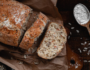 Sliced rye bread with a golden crust on cutting board. Healthy eating concept.