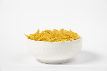 Raw Cavatappi Cellentani pasta in a plate isolated on white background top view