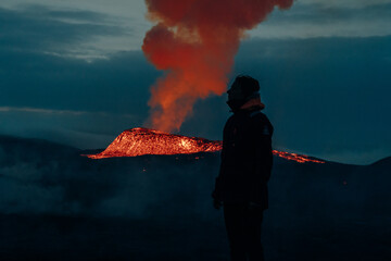 tourist looks at Fagradalsfjall, Iceland - June, 2021: volcano eruption near Reykjavik, Iceland