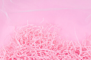 Fototapeta premium Calm pink background with tissue paper in present box