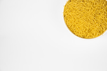 pasta for soup in a plate on white background