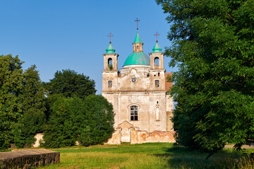 Fototapeta na wymiar Old ancient ruined catholic church of the Holy Trinity at summer. Benitsa, Minsk region, Belarus.