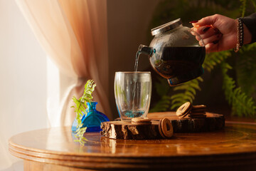 Woman hands pour Fresh Butterfly pea flower blue tea. Healthy detox herbal drink. Selective focus, close up