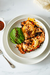 Fried Chili Spicy Egg Breakfast with Fresh Avocado on White Kitchen Background