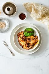 Fried Chili Spicy Egg Breakfast with Fresh Avocado on White Kitchen Background