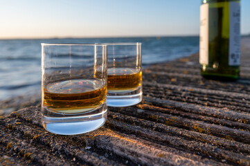 Drinking single malt Scotch whisky at sunset with sea, ocean or river view, private whisky tours in...