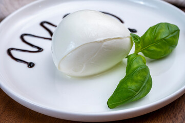 Tasing of fresh italian cheese mozzarella di buffalo with Balsamic vinegar from Modena
