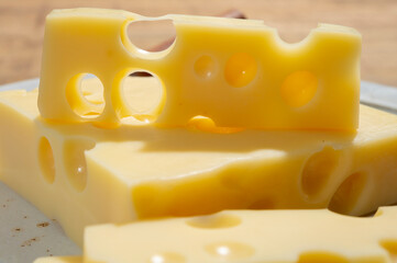 Cheese collection, blocks of French emmentaler cheese with many round holes made from cow milk