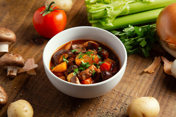 Cozy Bowl of Winter Beef Stew with Messy Kitchen Ingredients