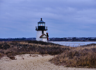Dusk and sunset at the Brant Point Light house at the entrance to Nantucket Harbor on the island of Nantucket