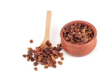 Raisins in a teaspoon. Raisins in a bowl isolated on a white background.