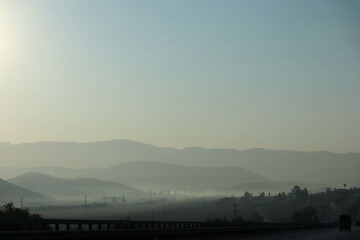 morning mist over the highway in the mountains